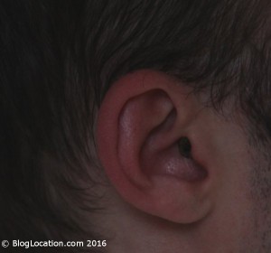 12_yellow_white_bilsom_303_foam_ear_plugs_cut_and_painted_side_view_wearing